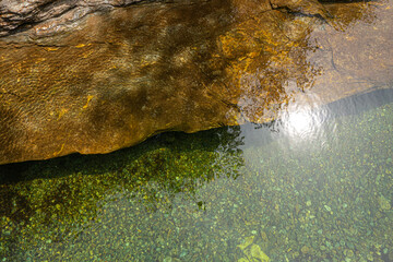 Top view of the water of a river and a rock bank. The wind gives the whole a superb texture. On the...