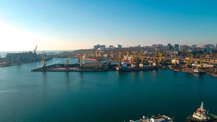 Naklejka premium Industrial port in the field of import-export global business logistics and transportation, Loading and unloading container ships, cargo transportation from a bird's eye view.