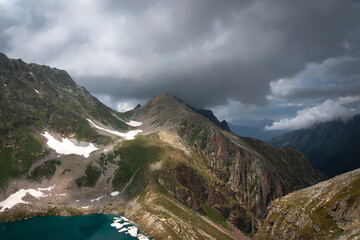 high-mountainous Murudjinskie lakes against the background of mountain peaks and remnants of snow...
