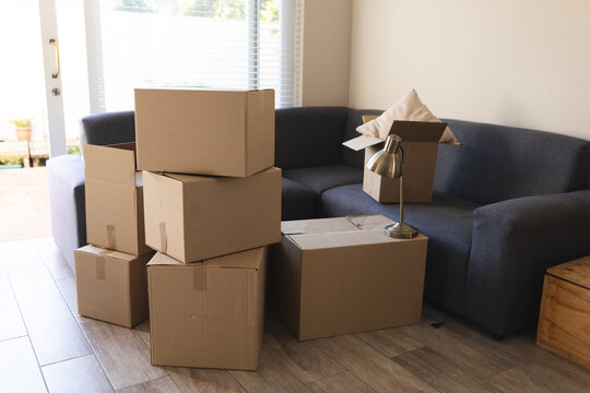Pile of boxes prepared before moving house next to couch