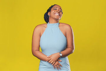 beautiful smiling african american girl in a blue dress, with pigtails hair rejoices on a yellow background