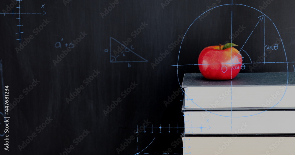 Poster apple on top of a pile of books and mathematical equations and graphs