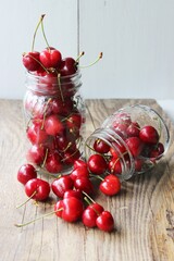 Merry. Berries in a jar on a wooden background. The concept of home preparations.