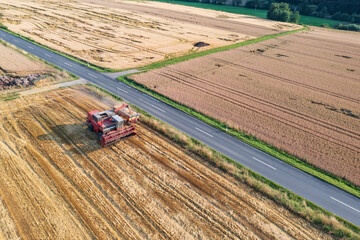 Top view of a combine harvester on a grain field during harvest in Taunus / Germany 