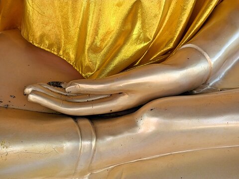Golden Buddha statue.  Close up hand of  Buddha statue.