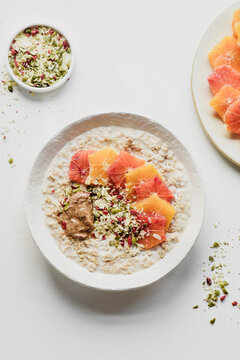 Porridge with colorful oranges, pumpkin seeds and peanut butter
