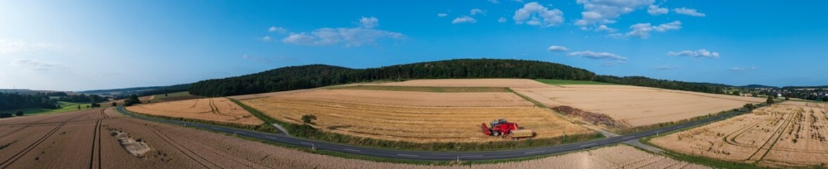 Top view of a combine harvester on a grain field during harvest in Taunus / Germany 