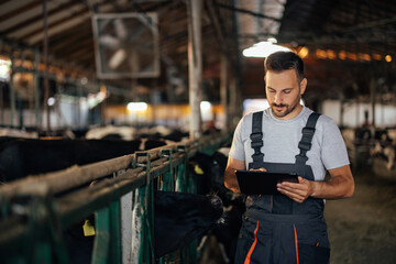Adult man, using his tablet, during work.