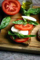Delicious caprese sandwiches on a wooden board. Keto sandwiches. Italy diet.