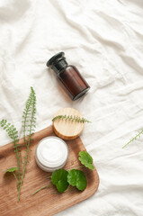 Sustainability concept cosmetic background brown glass veil with product flat lay green natural beauty bblog concept