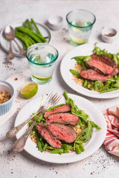 Beef slices with green beans and white sorghum