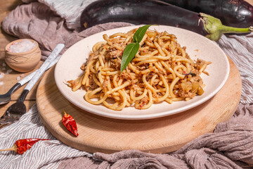 Traditional Sicilian pasta dish of sauteed eggplant topped with tomato sauce
