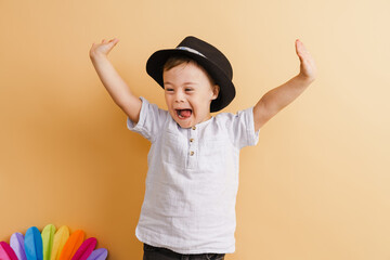 White boy with down syndrome in hat screaming and gesture at camera