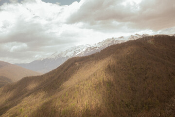 autumn summer landscape with clouds over the mountains