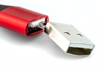 Macro shot of the red damaged end of the USB 2.0 A-Type cable, isolated on a white background.