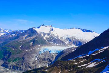 Looking down on the glacier from the helicopter window. It was amazing. A helicopter ride with a view of the glacier. Juneau, Alaska, USA. June 2019. © twabian