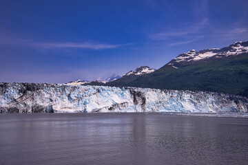 Obraz premium A view of the ice shelf in summer. Little snow on the top of the mountain. Enjoy the view of the ice shelf from the cruise ship. Alaska, USA. July 2019.