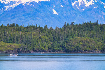 Fishermen pulling nets with their boats on a calm lake. Enjoy the view of the ice shelf from the...