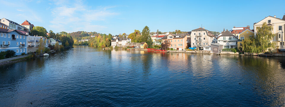 Traun river at Gmunden spa town, with houses at the riverside, austria in autumn
