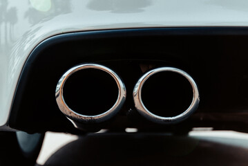 double exhaust pipe of a white sports car