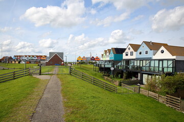 Fototapeta na wymiar Colorful houses alongside dike in Stavoren, Friesland, Netherlands 