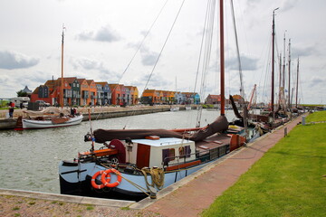 The fishing harbor of Stavoren, Friesland, Netherlands, with colorful houses and boats 
