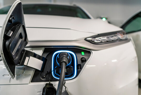 white electric vehicle in charge