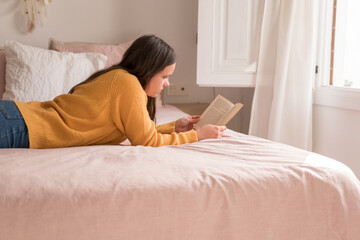 girl reading lying in bed