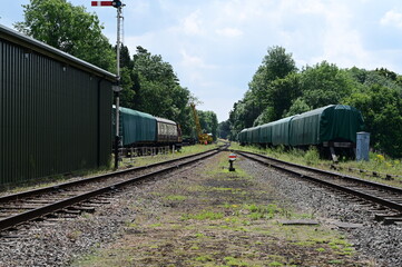 Obraz premium View up the railway track with a heavy lift crane in the distance.
