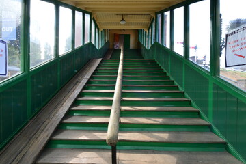 Wooden steps up to a passenger bridge on a heritage railway.