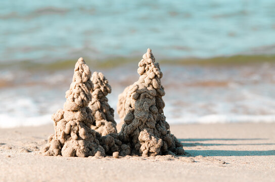 Photo of sand castle on the beach background