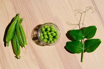 Green pea in glass bowl of top view on rustic wooden background with copy space