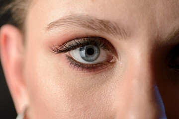 Close-up portrait of young woman with smoky eyes makeup.