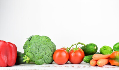 Healthy food, fresh assorted vegetables and tomatoes, isolated, on white background and copy space.