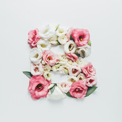 Fototapeta na wymiar Letter B made with flower and leaves on bright white background. Floral mother's day alphabet concept. Spring blossom, valentine or romantic font collection. Flat lay, top view.
