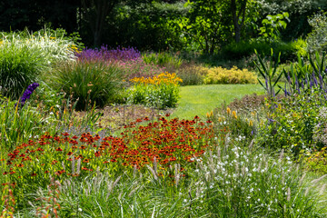 Mature garden influenced by the philosophy of naturalistic planting, with emphasis on layering,...