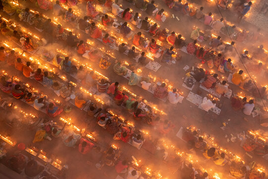 View of a crowd of people celebrating Rakher festival with oil lamp and burning incense in Narayanganj, Bangladesh.