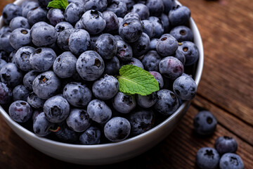 Fresh blueberries in a bowl close-up. Healthy food, fruit background.