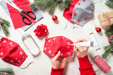 Woman sewing Creative handmade christmas face mask. Zero waste christmas, creative present concept....