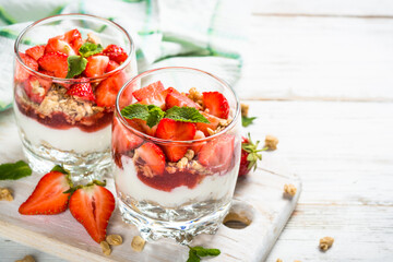 Parfait dessert. Yogurt with fresh strawberry and granola.