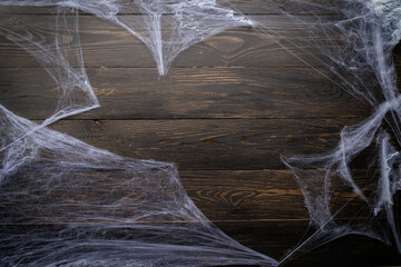 Halloween holiday background with spider web on black wooden backdrop