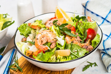 Seafood salad with fresh leaves tomatoes and fried seafood. Mediterranean diet.