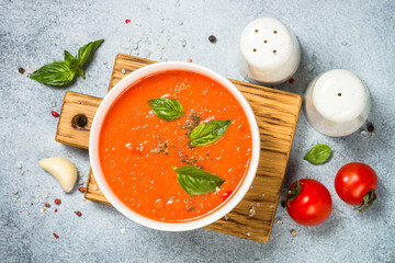 Tomato soup with basil. Top view at white background.
