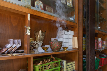 Incense  smoke rises from a cup on a gift shop shelf in Christian quarters in the old city of Jerusalem, Israel