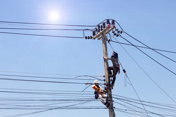 Electrician is installing an electrical wiring system on a power pole