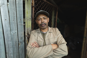Portrait of african american male gardener with crossed hands looking at camera at garden centre
