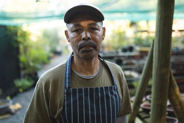 Portrait of african american male gardener looking at camera at garden centre