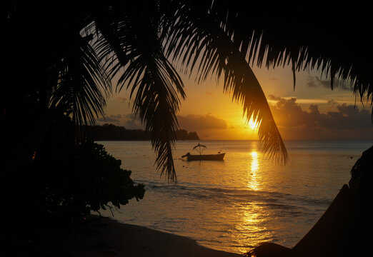 View of a traditional fishing boat anchoret along the shoreline at Desroches Island in Seychelles.