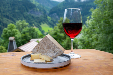 Cheese collection, French cheese tomme de savoie, glass of red wine from Savoie and french...
