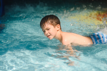 boy is in the water park.
